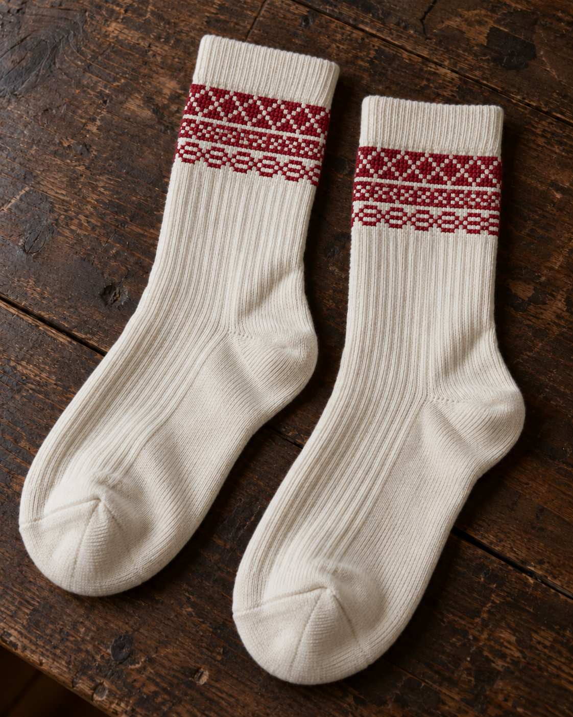 Design mock-up of baker's wife tatreez socks in cream, showing cross-stitch details.