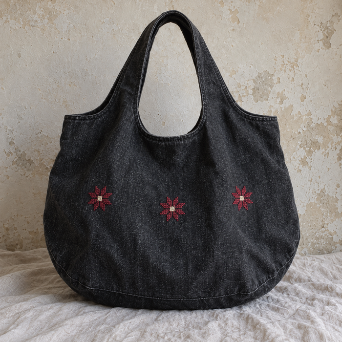Rounded charcoal denim tote with three burgundy Bethlehem star motifs