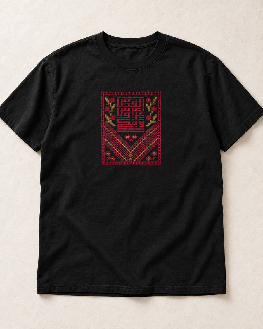 Black Kufic Floral Tatreez T-Shirt with burgundy and muted gold embroidery, flat lay