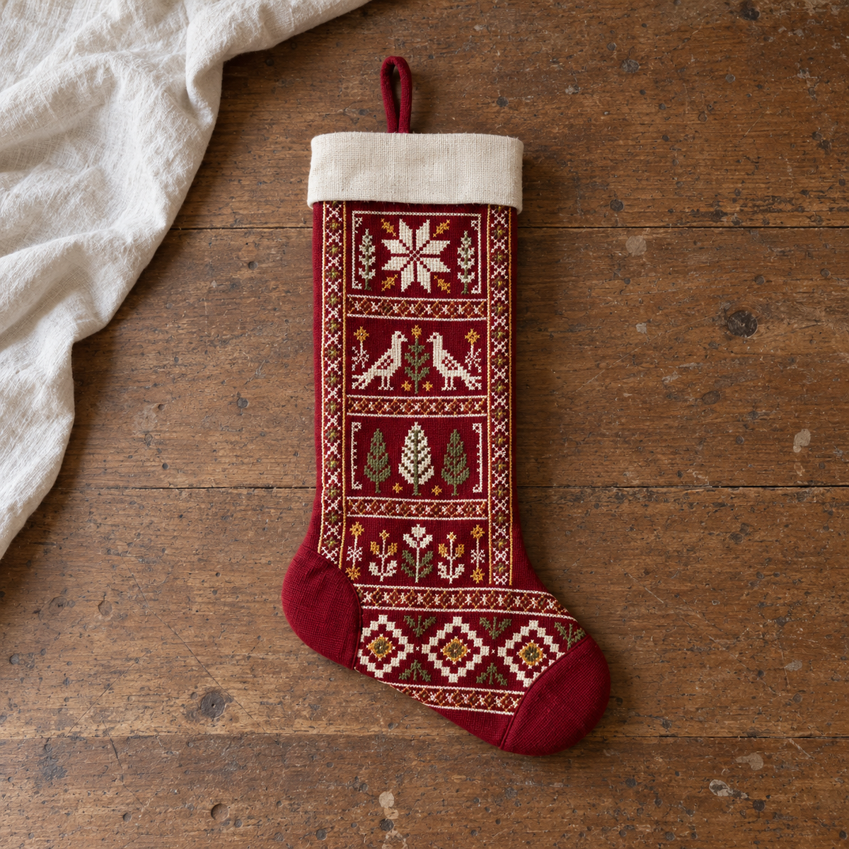 Bird and Star Tatreez Christmas Stocking - Burgundy - full stocking on a wooden table