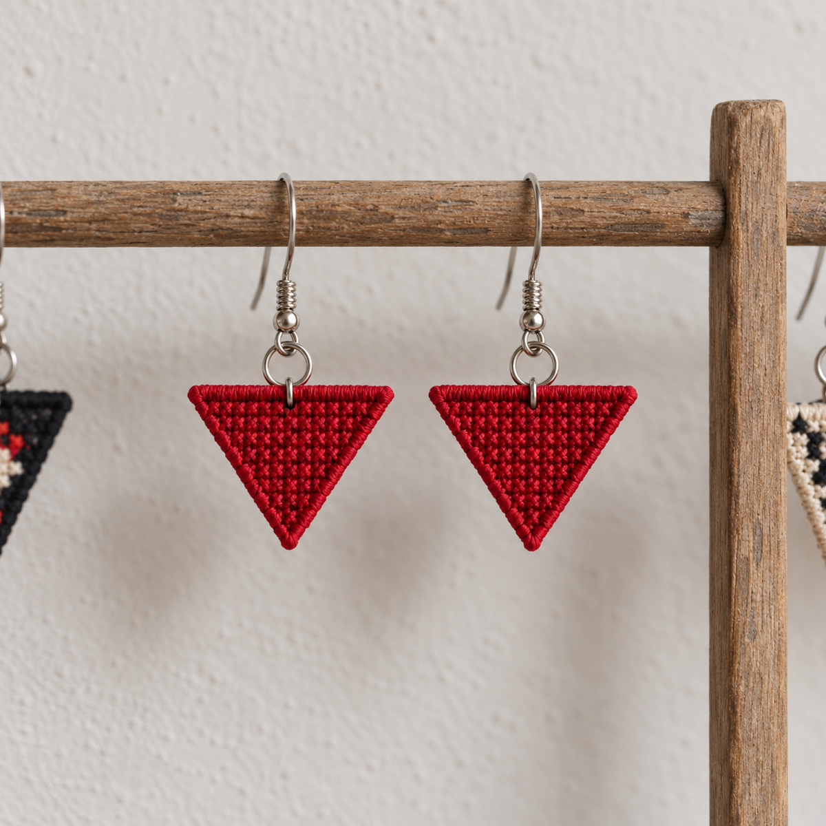 Red Triangle Tatreez Earrings - pair hanging on display