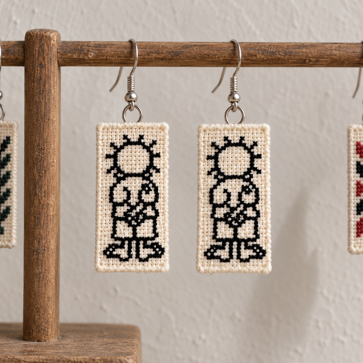 Handala Tatreez Earrings - pair hanging on display