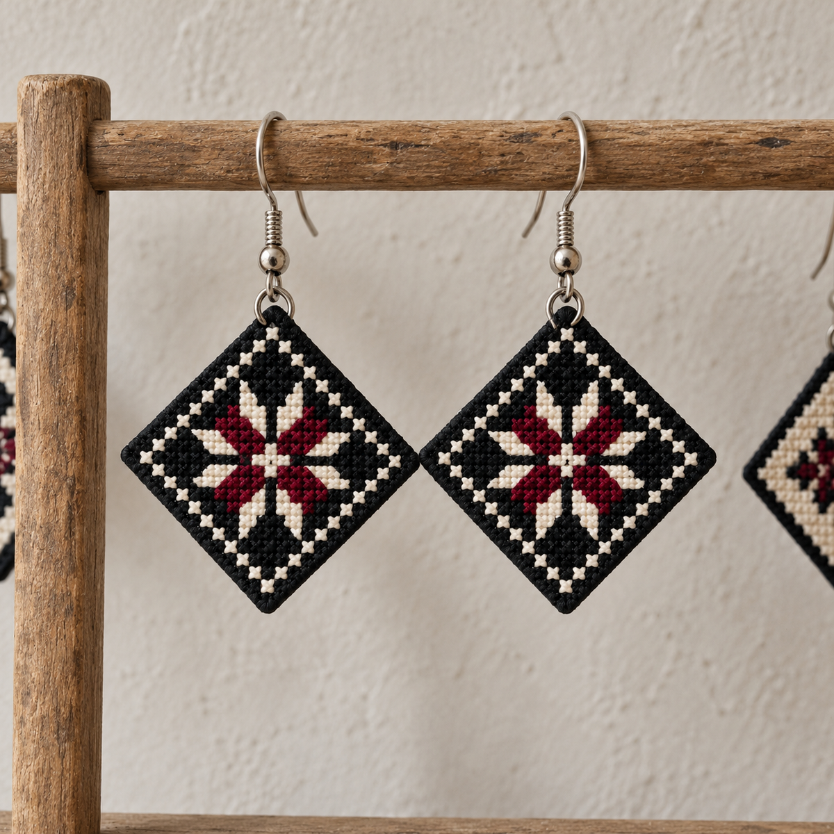 Bethlehem Star Tatreez Earrings - Black - pair hanging on display