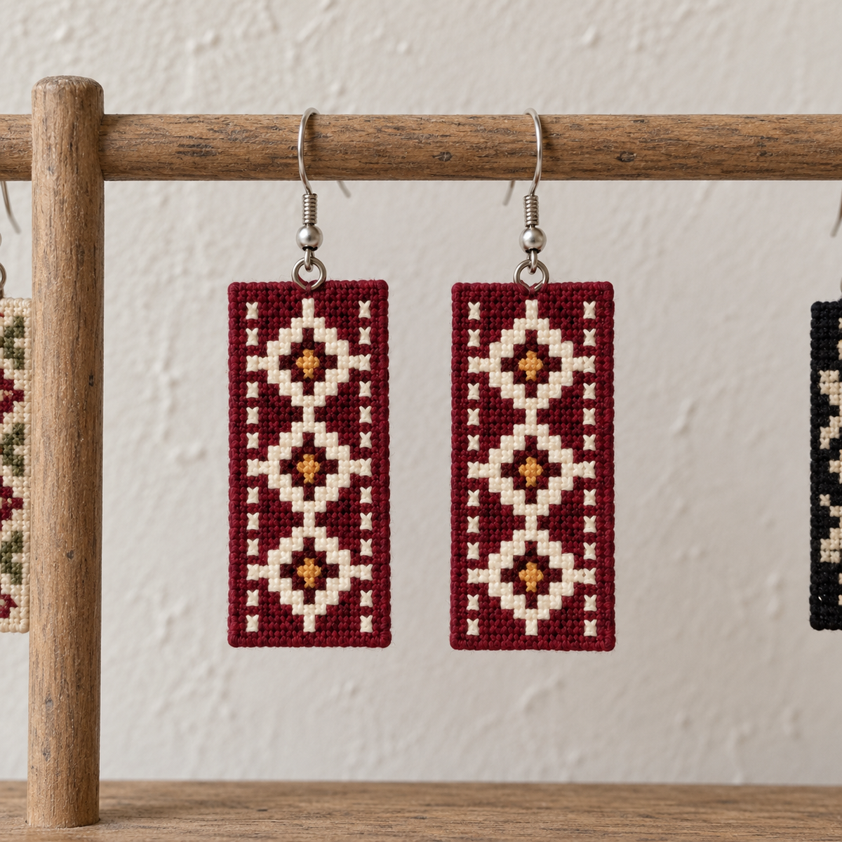 Geometric Tatreez Earrings - Burgundy - pair hanging on display