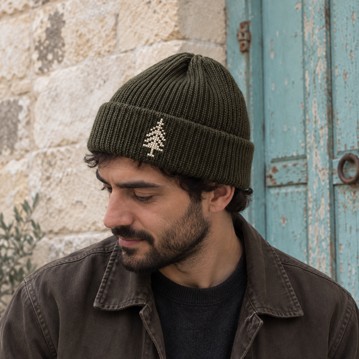 Cypress Tree Tatreez Beanie - Olive worn on an adult model