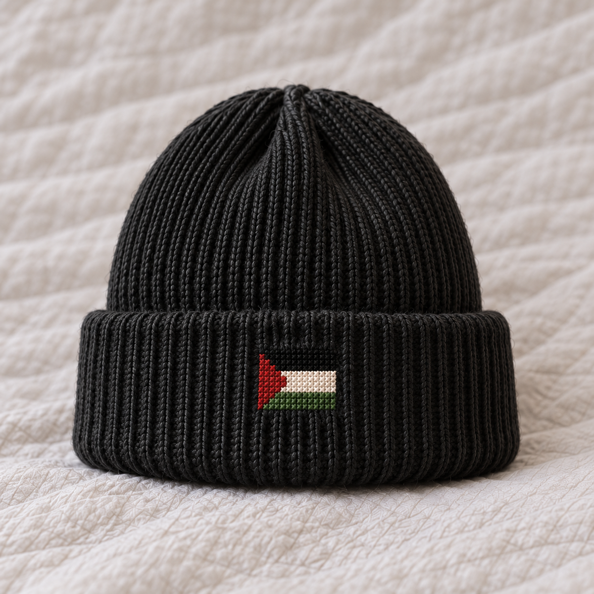 Tiny flag3cm wide, black white green stripes red left triangle stitched directly on cuff, no patch.