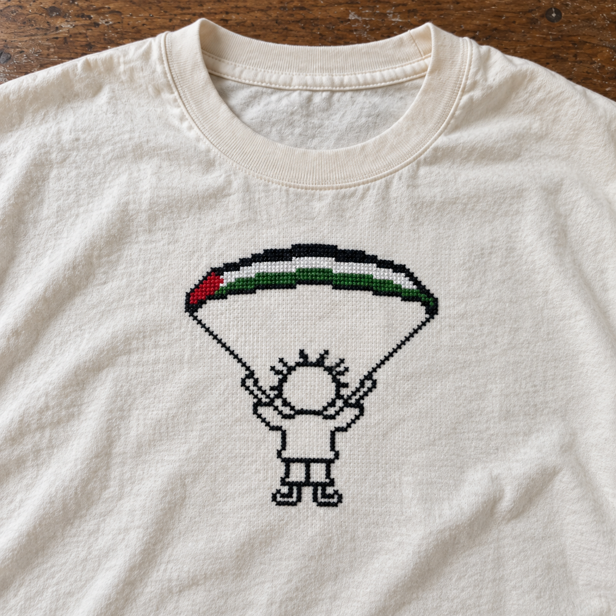 Close-up of Handala and Palestinian flag parachute embroidery