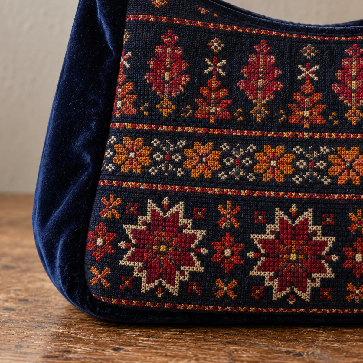Close-up of fine tatreez embroidery and midnight navy velvet