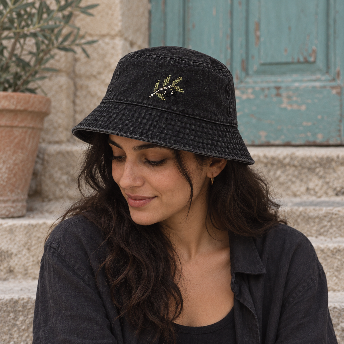 Olive Branch Tatreez Bucket Hat - Black worn on an adult model