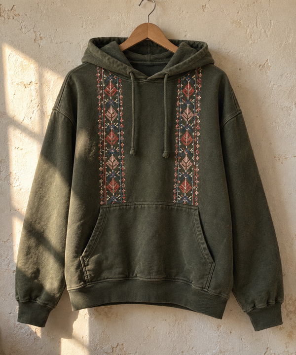 Olive hoodie with two vertical embroidered tatreez bands down the front.