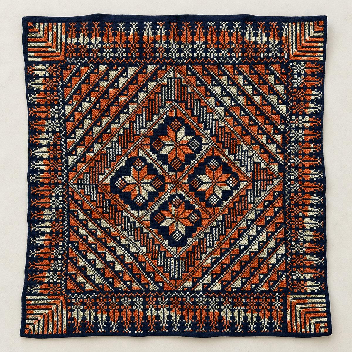 Orange and Ivory Tatreez Cushion Cover - Navy, embroidered front laid flat