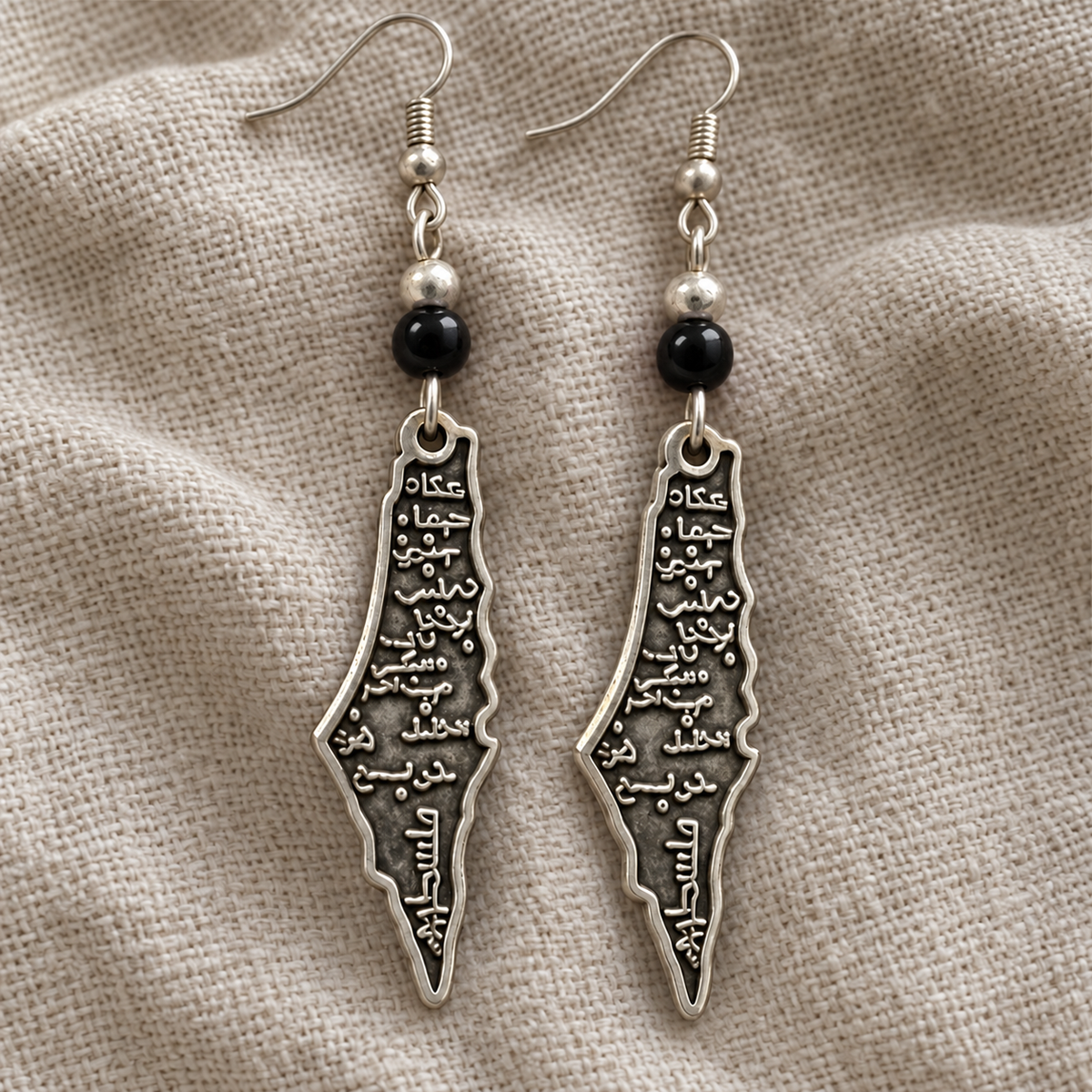 Palestine map earrings with round black beads and revised Arabic lettering