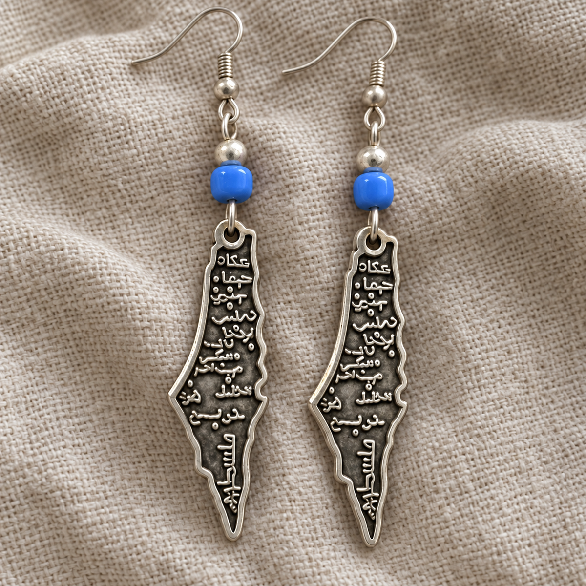 Palestine map earrings with blue barrel beads and revised Arabic lettering
