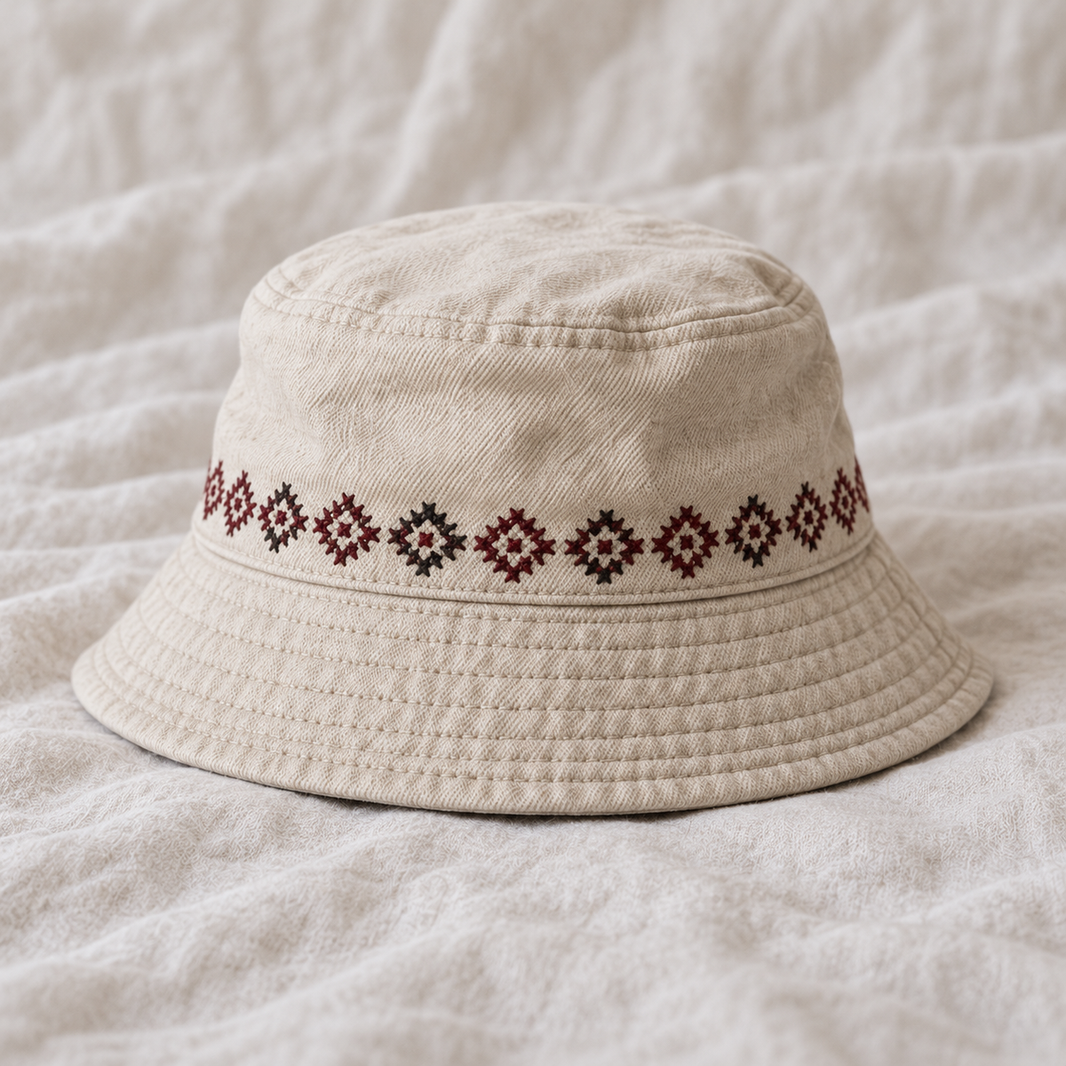 Narrow burgundy charcoal repeating geometric band around crown above brim.