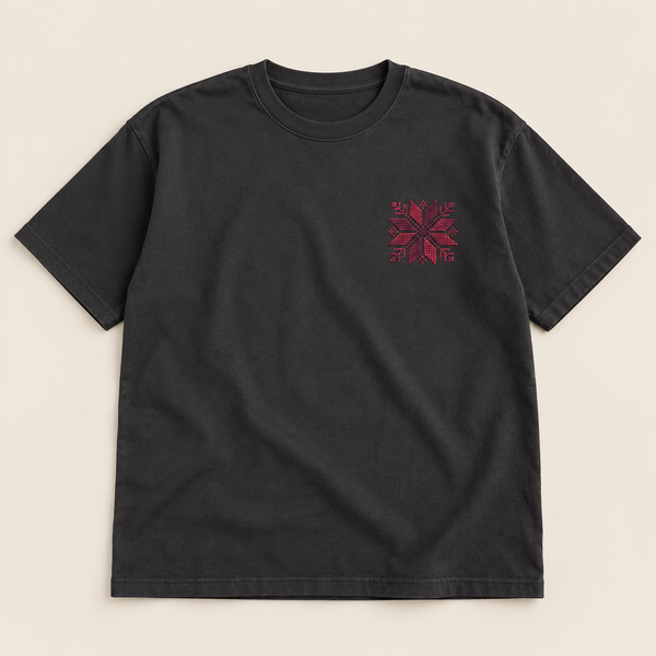 Charcoal T-shirt laid flat with a small burgundy floral star embroidered on the left chest.