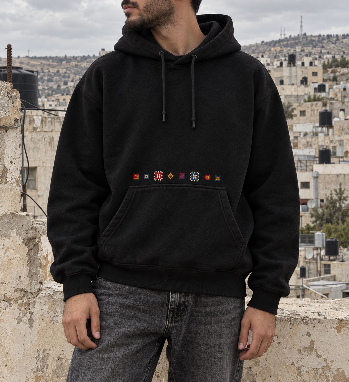 Tatreez Pocket Line Hoodie - Black - model on rooftop